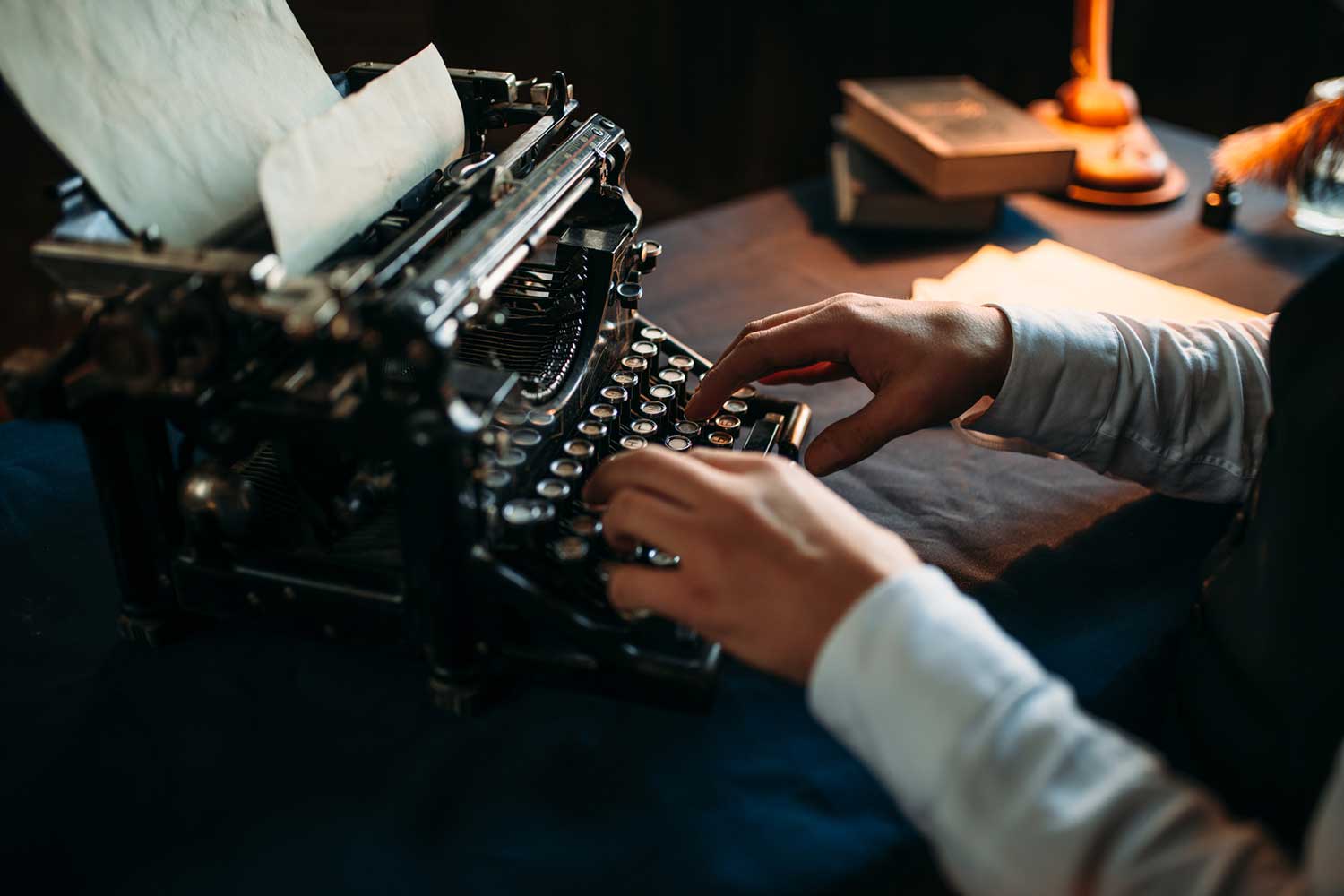 person typing on a typewriter